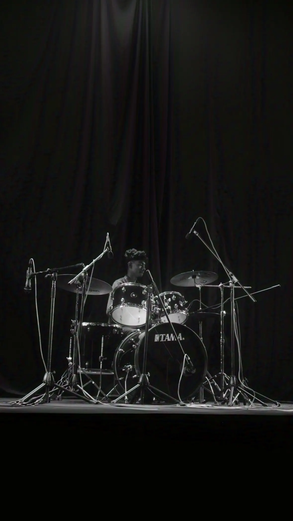 Silhouette behind the drum kit